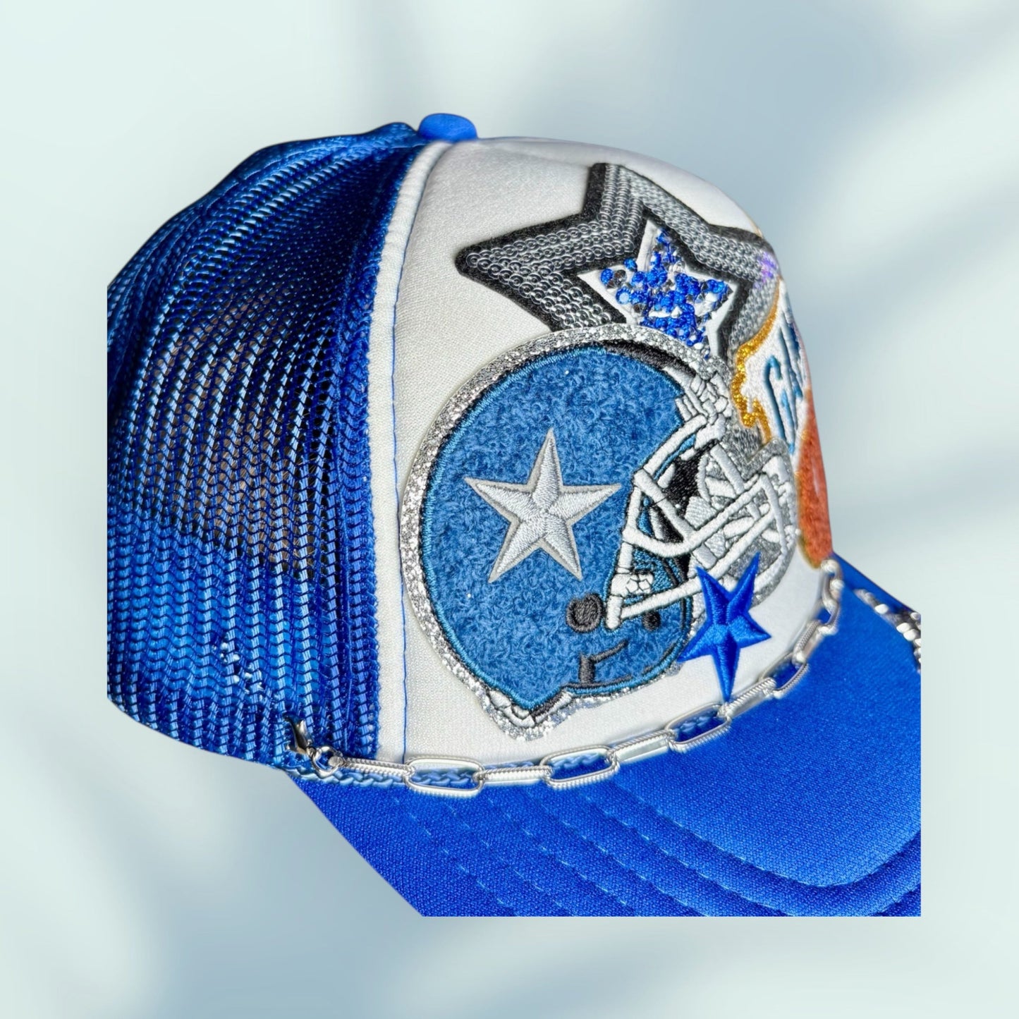 Blue and white cap with star designs on a light gray background