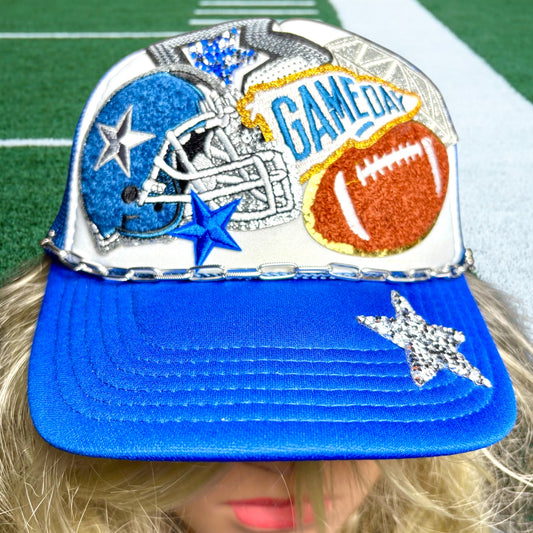 blue cap with football-themed decorations including a helmet, star, and 'Game Day' banner